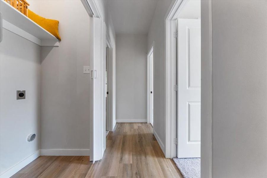 Corridor with light hardwood / wood-style floors