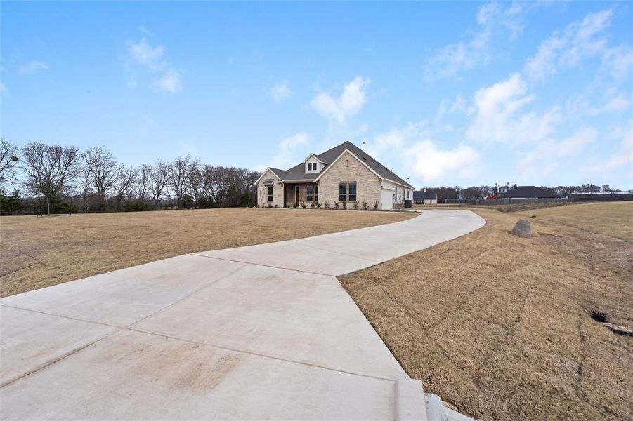 Front exterior of a new home in Nash Estates, Tom Bean, TX, highlighting curb appeal (Image 23). Front exterior of a new home in Nash Estates, Tom Bean, TX, highlighting curb appeal (Image 23).