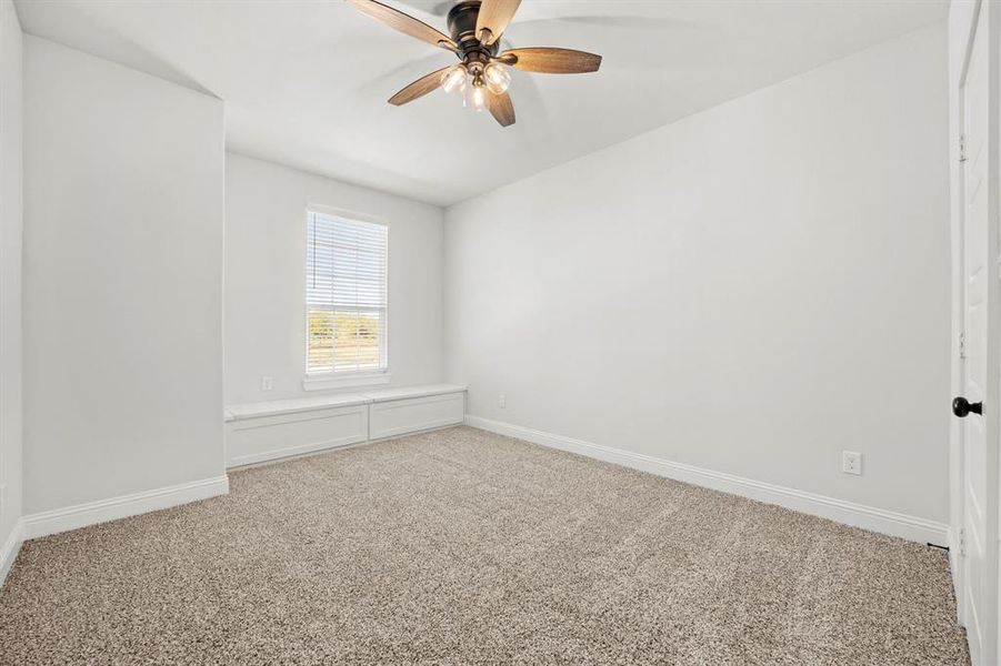 Carpeted empty room with ceiling fan