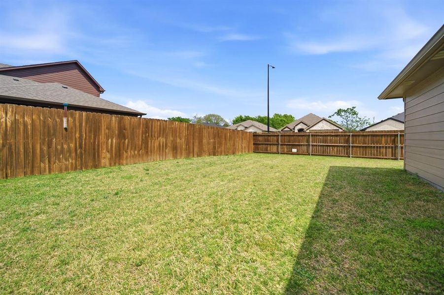 View of fenced backyard