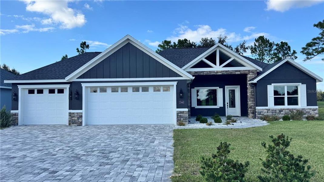 Front exterior of a new home in Juliette Falls, Dunnellon, FL, highlighting curb appeal (Image 1).