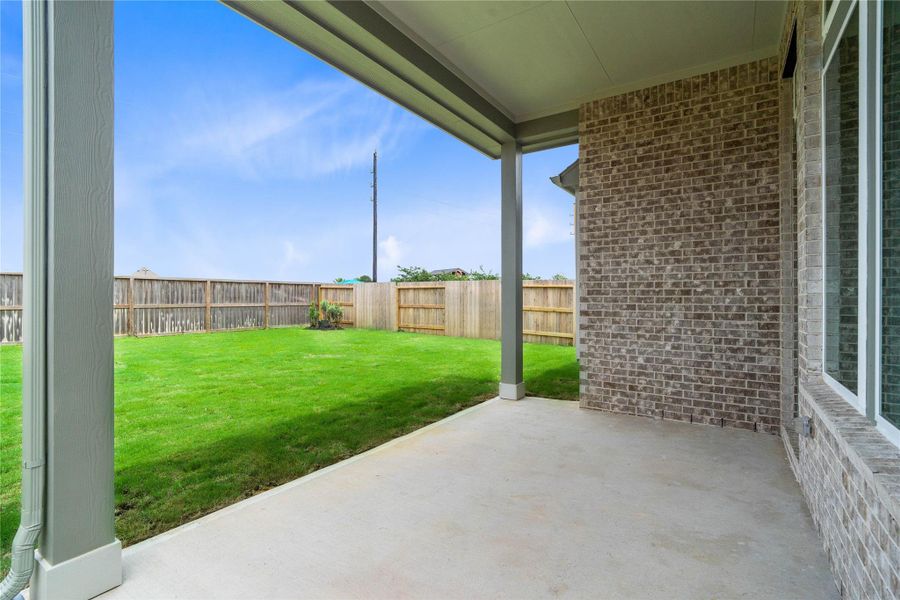 Step outside to back patio and spacious back green space.