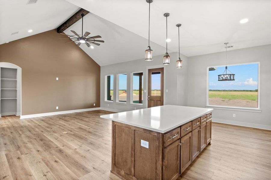 Kitchen featuring beamed ceiling, pendant lighting, healthy amount of natural light, a ceiling fan, and recessed lighting Kitchen featuring beamed ceiling, pendant lighting, healthy amount of natural light, a ceiling fan, and recessed lighting