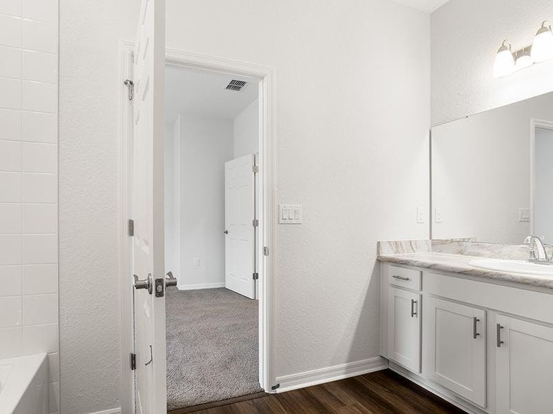 Suites 2 and 3 include a single-vanity en-suite bath with a linen closet - Everly by Highland Homes
