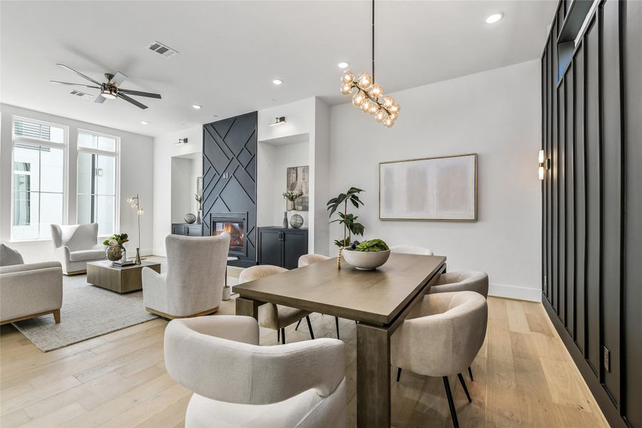 From this angle, the dining area’s craftsmanship shines—custom millwork wall, wide-plank white oak floors, and designer lighting define the aesthetic. The open flow extends to the living room, highlighting the home’s spacious design and timeless architectural appeal. From this angle, the dining area’s craftsmanship shines—custom millwork wall, wide-plank white oak floors, and designer lighting define the aesthetic. The open flow extends to the living room, highlighting the home’s spacious design and timeless architectural appeal.