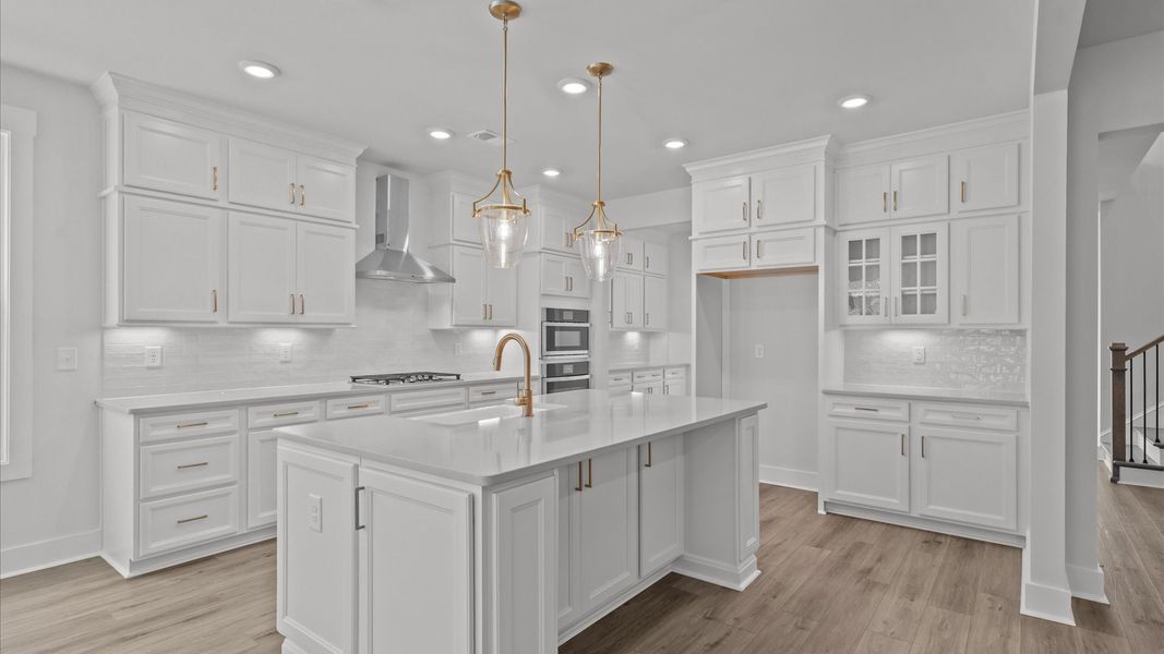 Notable kitchen space with elegant pendant lighting and a large island perfect for entertaining