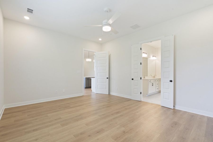 Expansive room featuring wood-finish flooring, recessed lighting, and a ceiling fan