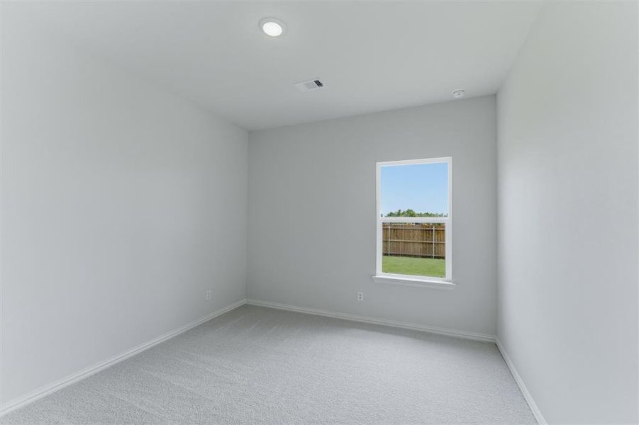 Neutral-toned room featuring a single window, recessed lighting, light gray wall paint, white trim, and gray carpeting