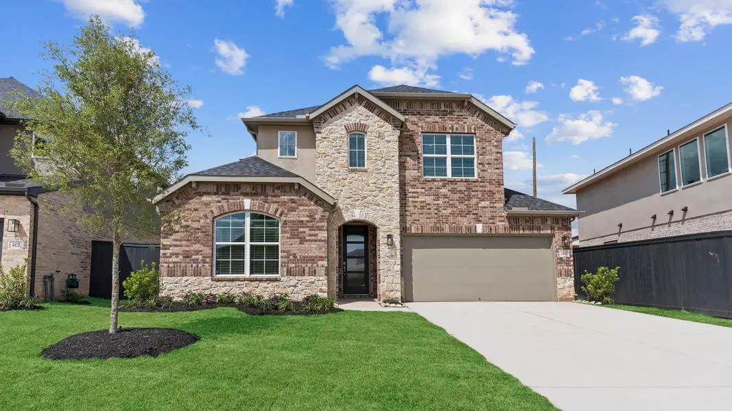 Front exterior of a new home in Westland Ranch 60' Homesites, League City, TX, highlighting curb appeal (Image 1).