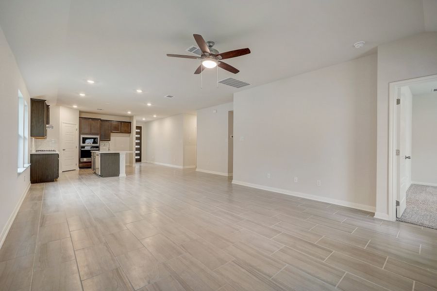 Living room, dining room, and kitchen in the Oleander floorplan at a Meritage Homes community.