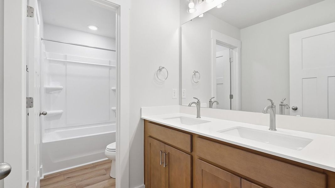 Top-notch bathroom with current fixtures, tasteful materials, and elevated charm at the Woodglen community