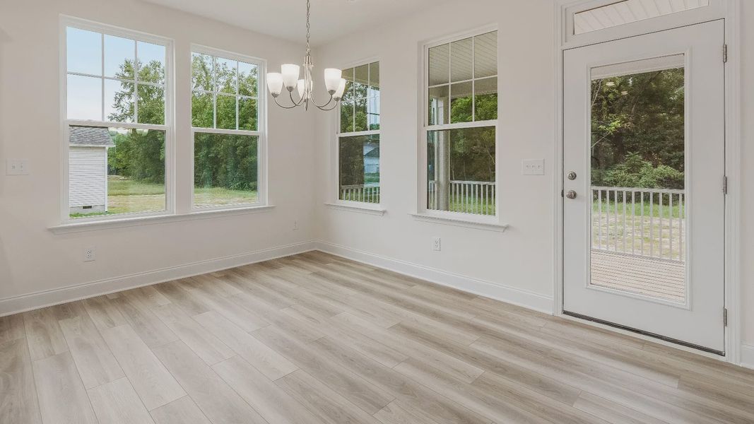 Stonehaven home plan breakfast area adjacent to the kitchen with access to rear porch