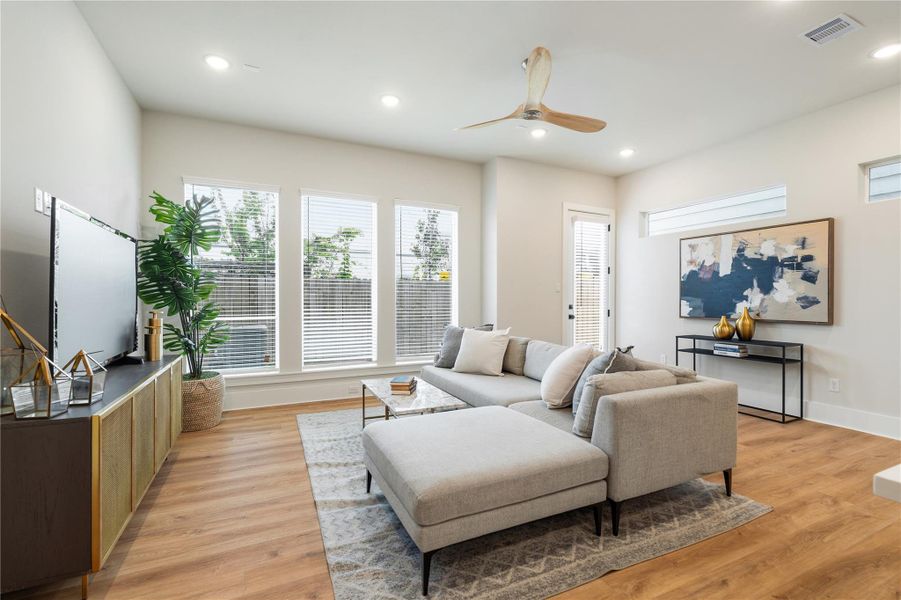 Defined by its scale and light, the living room is anchored by a wall of picture-style windows that enhance both openness and connection to the outdoors. Defined by its scale and light, the living room is anchored by a wall of picture-style windows that enhance both openness and connection to the outdoors.