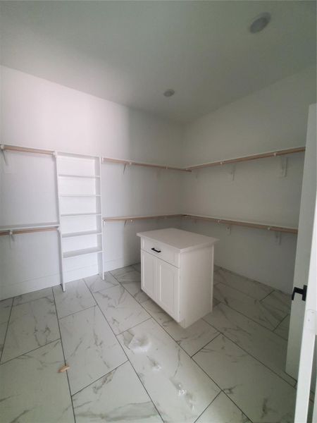 HUGE PRIMARY CLOSET WITH COUNTERTOP ISLAND FOR EXTRA STORAGE.