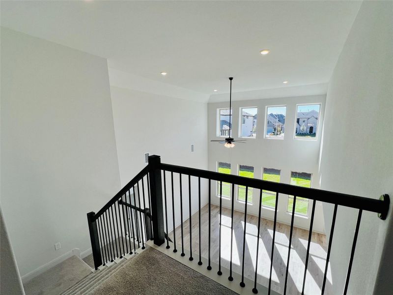 Stairway with carpet floors, recessed lighting, and a ceiling fan
