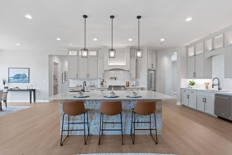 Kitchen featuring appliances with stainless steel finishes, custom exhaust hood, backsplash, light wood-style floors, and recessed lighting