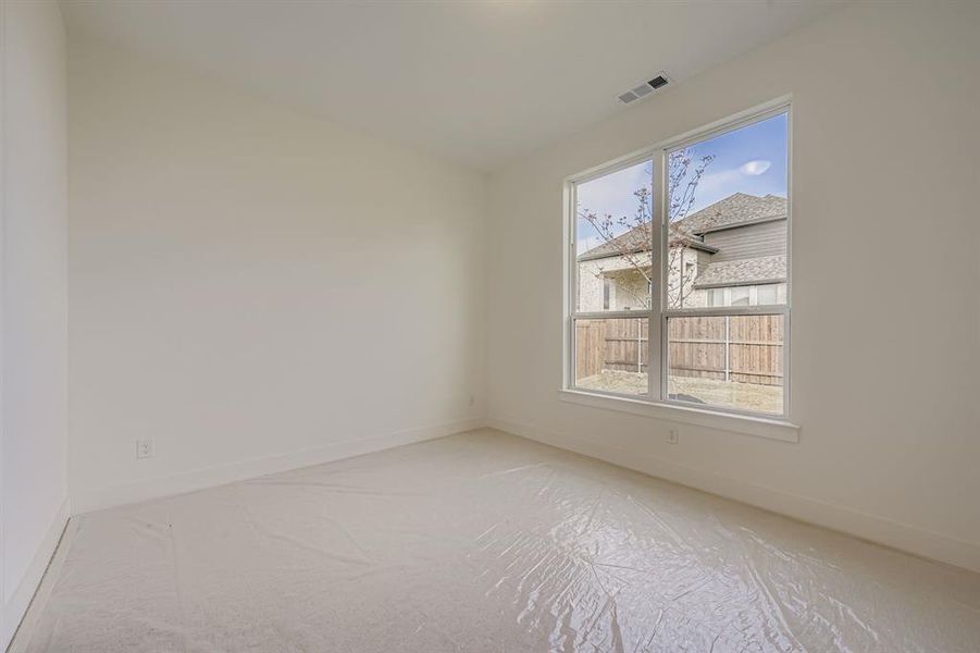 Spare room featuring baseboards