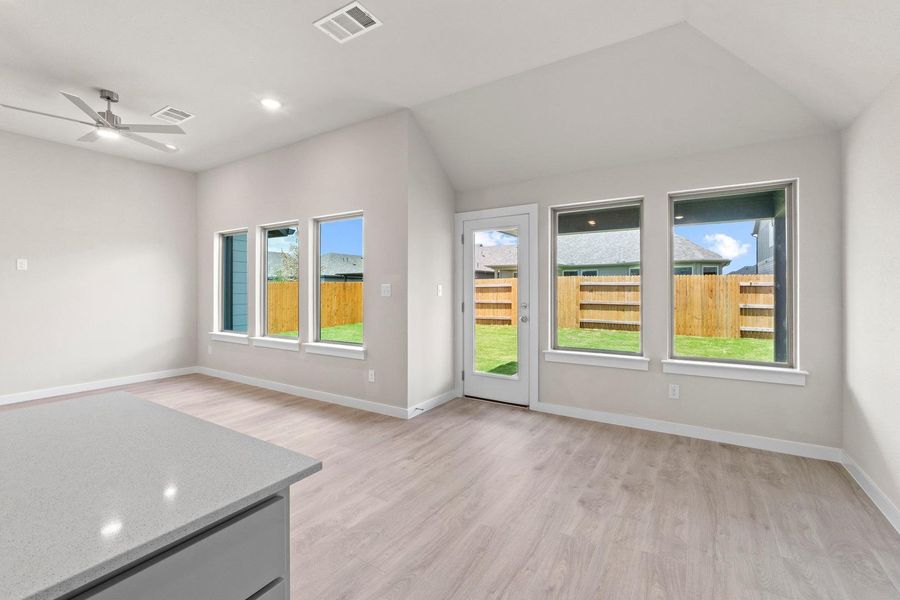 Natural light floods this inviting living space, highlighting modern flooring and outdoor access.