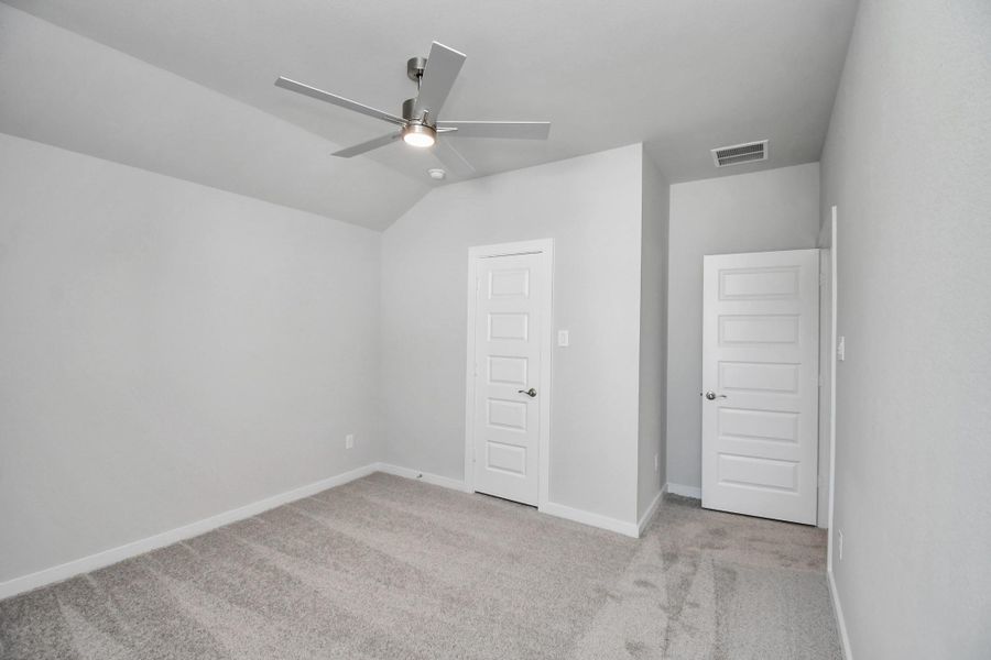 Generously sized secondary bedrooms featuring spacious closets, soft and inviting carpeting underfoot, large windows allowing plenty of natural light, and the added touch of privacy blinds for your personal retreat. Sample photo of completed home with similar floor plan. Actual colors and selections may vary.