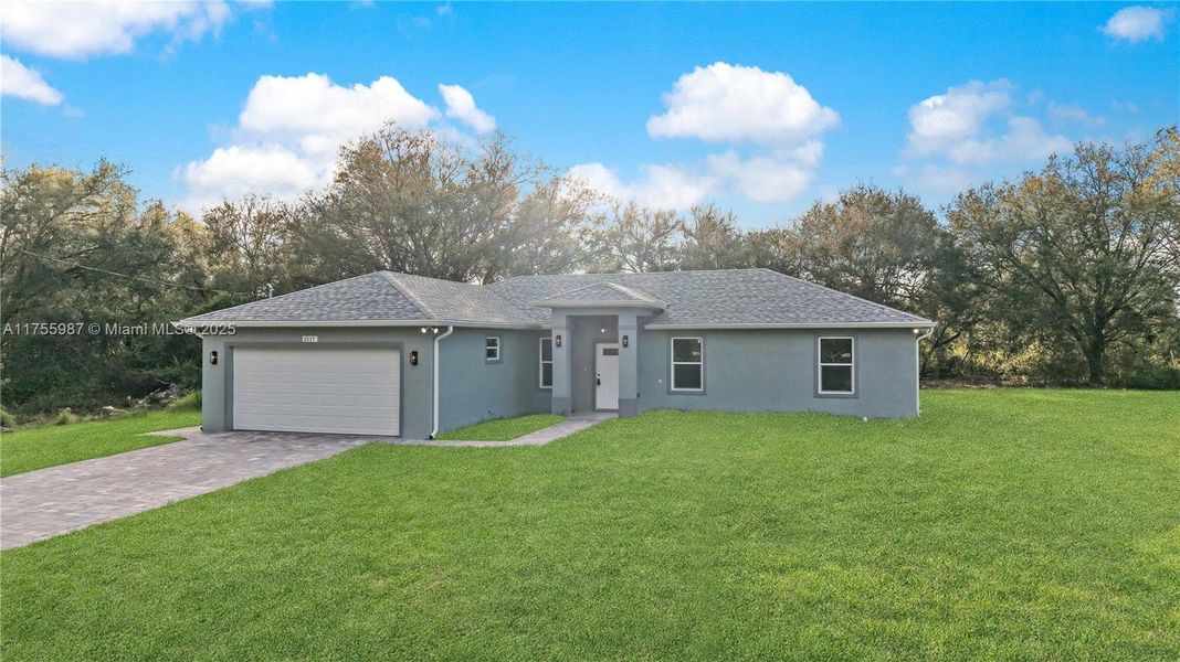 Front exterior of a new home in , Lehigh Acres, FL, highlighting curb appeal (Image 13).