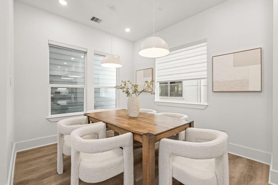The dining area unfolds naturally from the kitchen, its placement guided by proportion and spatial continuity to create an effortless relationship between gathering and conversation.
