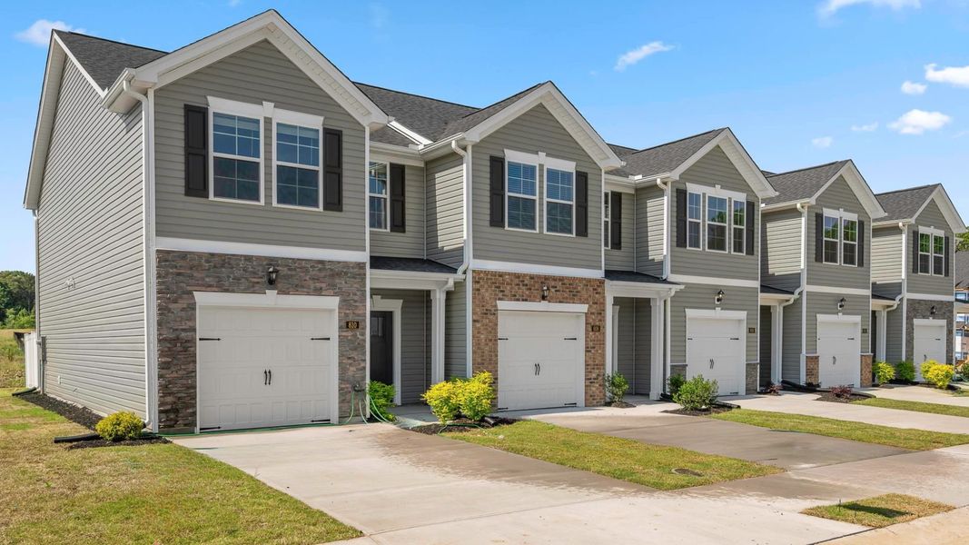 Front exterior of a new home in The Gables at Edinborough Townes, Gibsonville, NC, highlighting curb appeal (Image 1). Front exterior of a new home in The Gables at Edinborough Townes, Gibsonville, NC, highlighting curb appeal (Image 1).