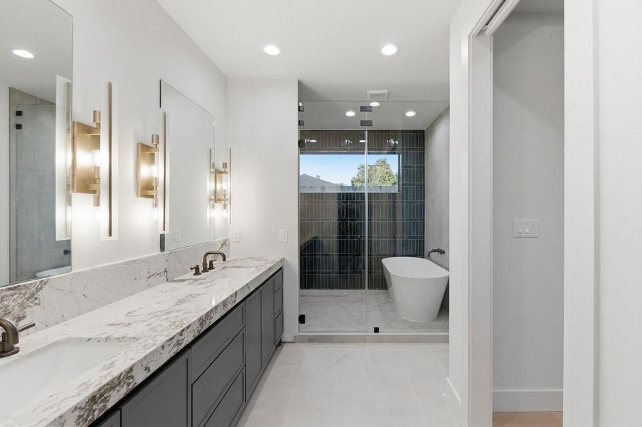 The sophisticated primary bathroom offers a relaxing retreat with a spacious layout, premium fixtures, and timeless style.