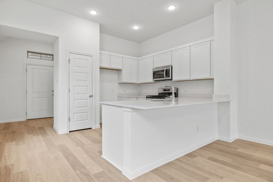 Kitchen in the Birch home plan by Trophy Signature Homes – REPRESENTATIVE PHOTO