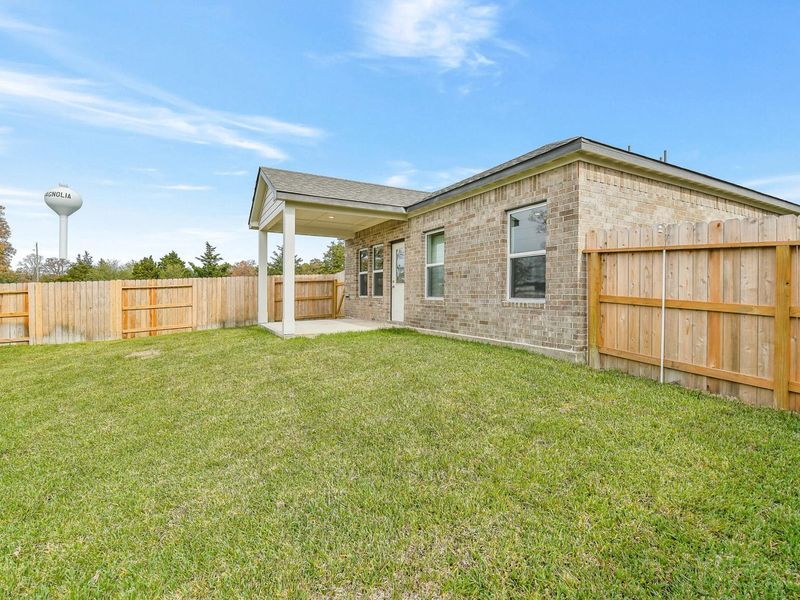 Exterior details and patio area of a home in Windmill Estates, Magnolia (Image 21).