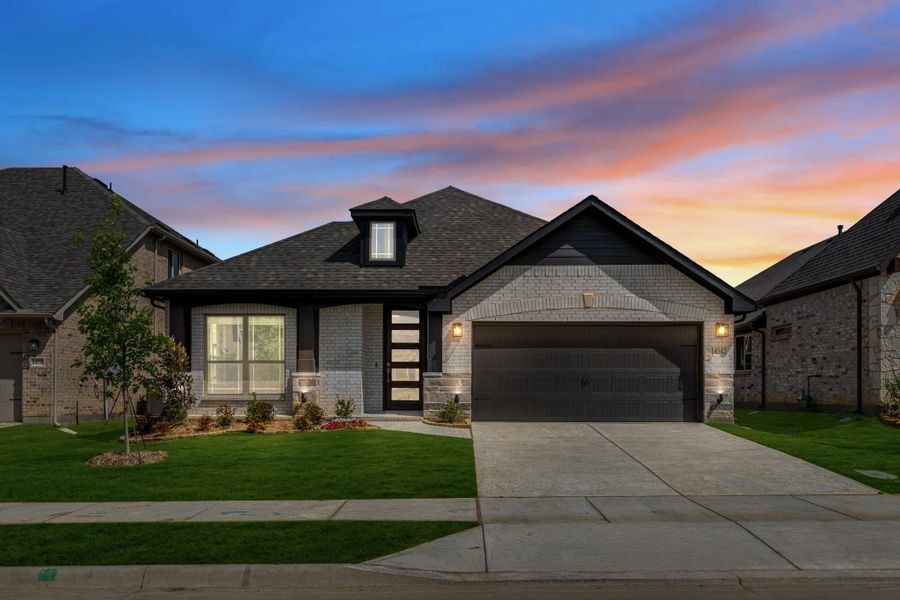 Single-story home with stone and brick exterior, two-car garage, and landscaped front yard