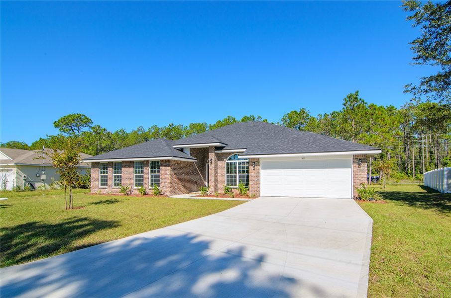 Front exterior of a new home in Palm Coast, Palm Coast, FL, highlighting curb appeal (Image 20).