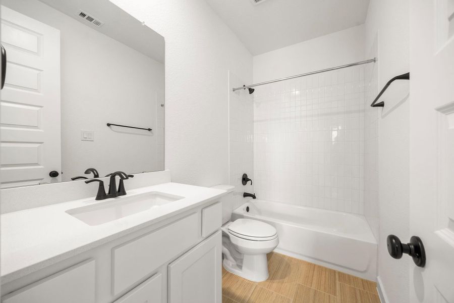 The ensuite bathroom connected to the first guest bedroom downstairs.