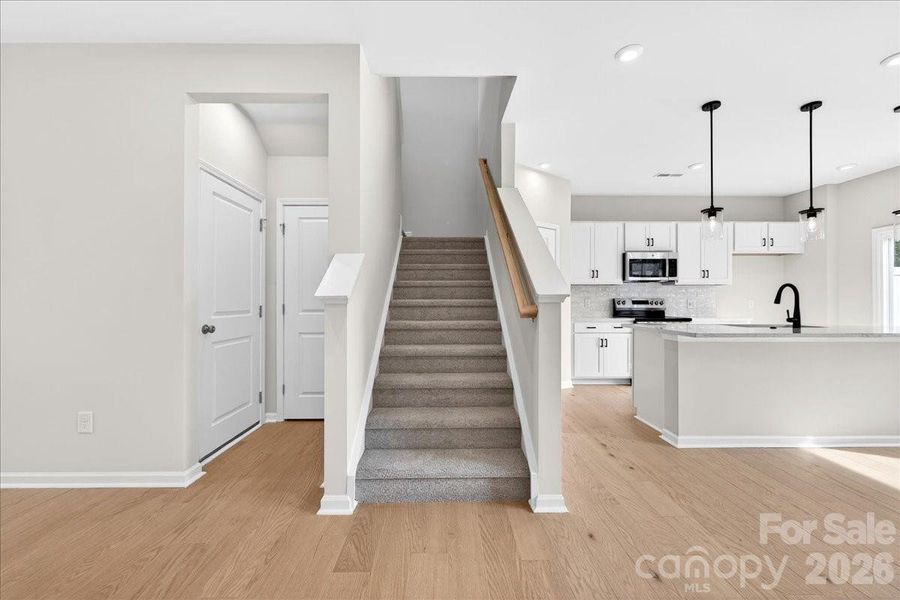 Coat closet and garage entry to the left of stairs Coat closet and garage entry to the left of stairs
