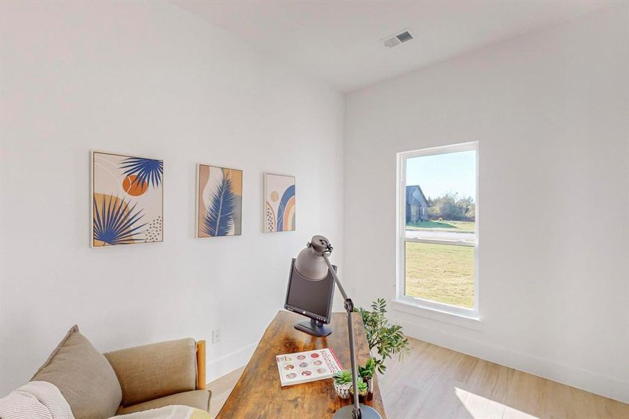 Home office featuring plenty of natural light and light hardwood / wood-style flooring