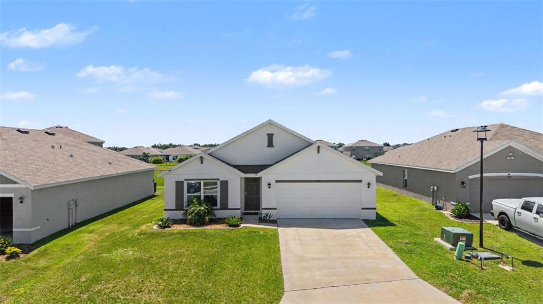 Front exterior of a new home in Mandarin Grove, Palmetto, FL, highlighting curb appeal (Image 25).