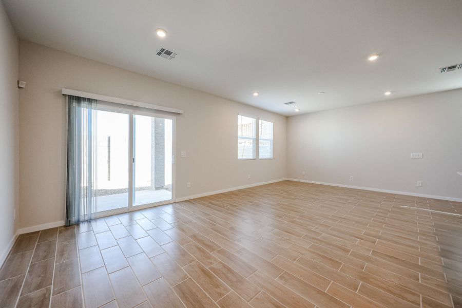 A room with a wood floor and a wood floor with a window. A room with a wood floor and a wood floor with a window.
