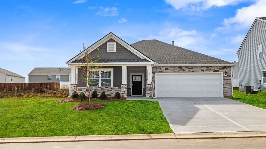 Front exterior of a new home in Durbin Meadows Traditions, Fountain Inn, SC, highlighting curb appeal (Image 1).