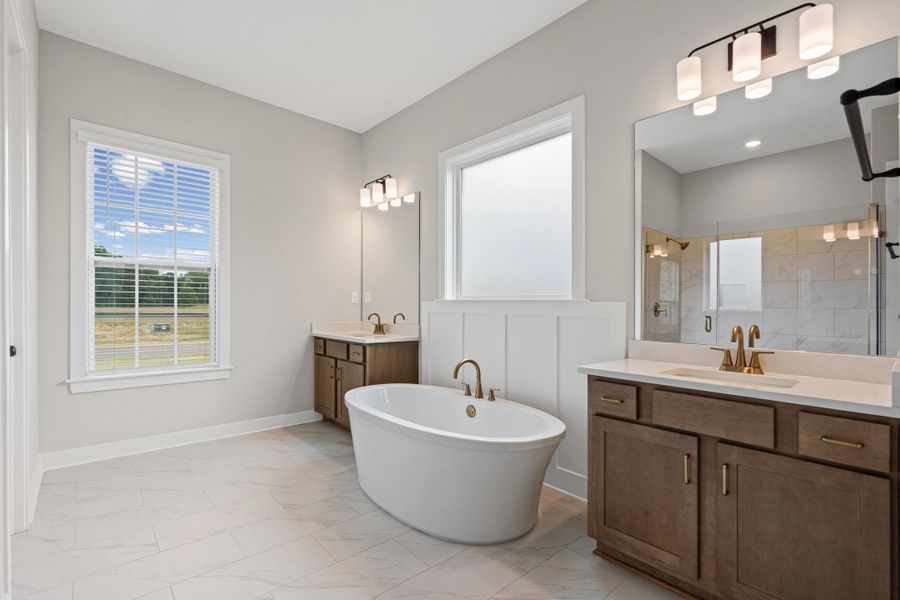 Freestanding soaking tub with gold-finish fixtures Freestanding soaking tub with gold-finish fixtures