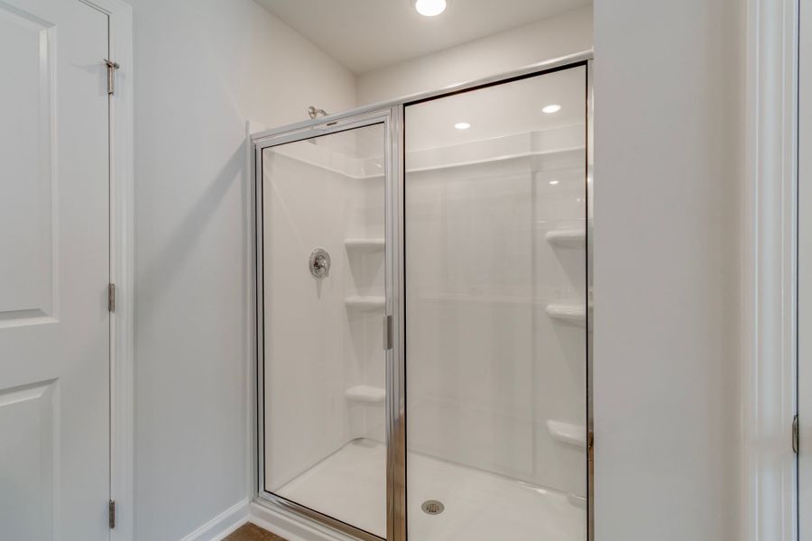 Create a relaxing space in the Longspur Owner's Bath including a dual vanity and walk-in shower.