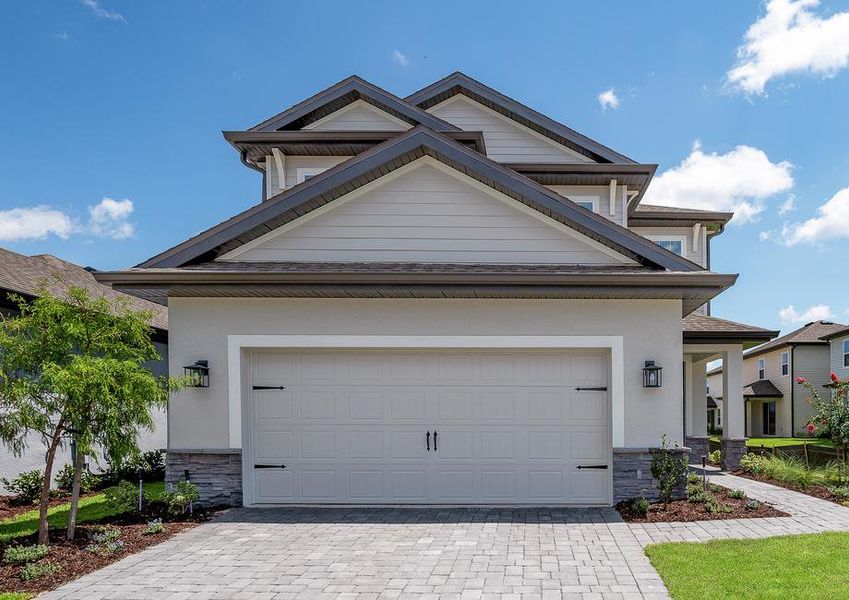 Two-story home with stone detail and landscaping.