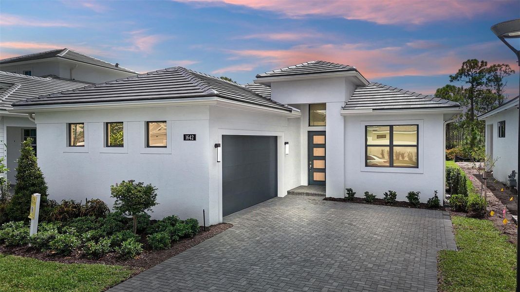 Front exterior of a new home in Cove Royale, Stuart, FL, highlighting curb appeal (Image 2). Front exterior of a new home in Cove Royale, Stuart, FL, highlighting curb appeal (Image 2).