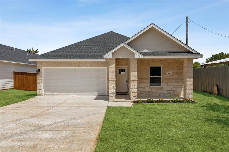 View of front facade with a garage and a front yard