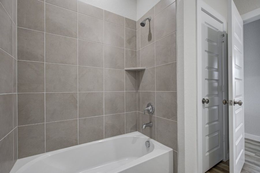 A bathroom with a bathtub and shower. A bathroom with a bathtub and shower.