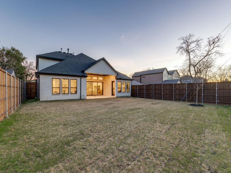 Back of house featuring a patio and a large, fenced backyard Back of house featuring a patio and a large, fenced backyard