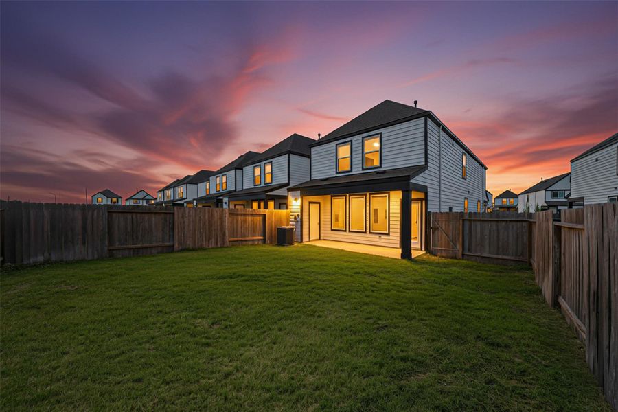 The spacious fenced backyard and private patio offers plenty of room for relaxing or entertaining. (Digitally improved).
