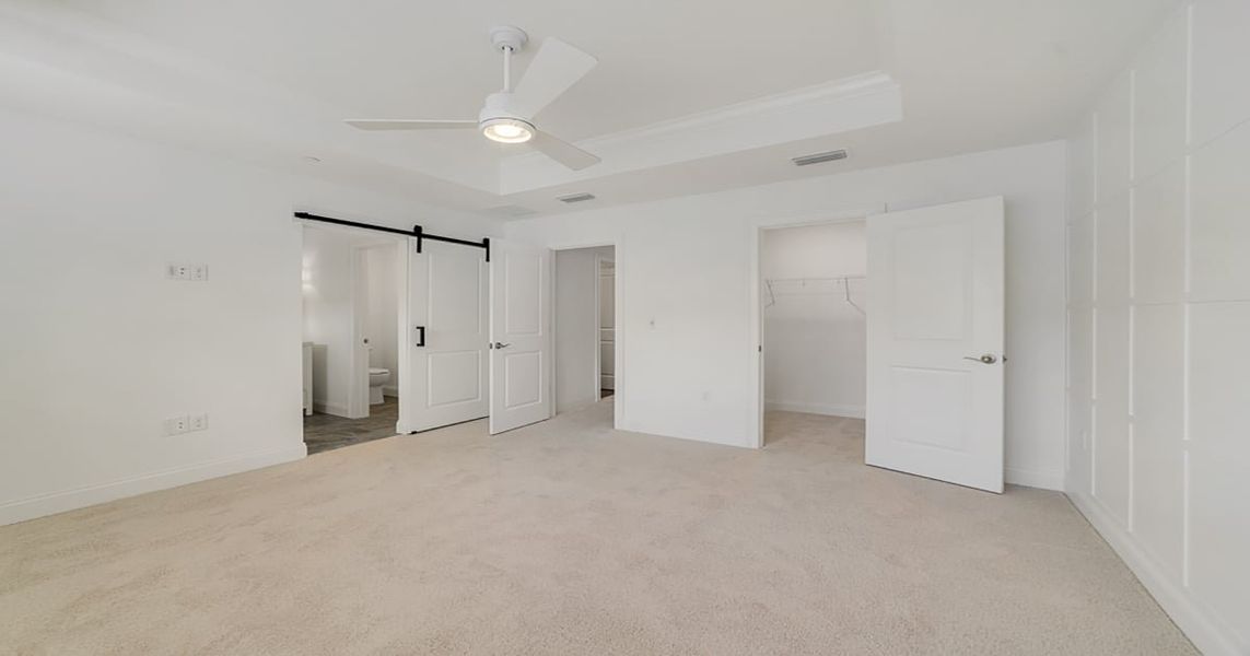 Primary suite with decorated feature wall & tray ceiling Primary suite with decorated feature wall & tray ceiling