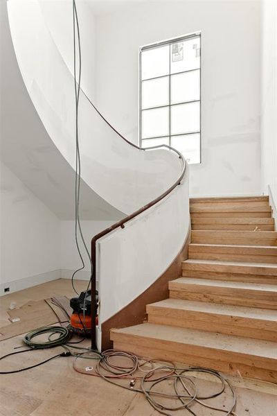 Staircase featuring hardwood / wood-style flooring