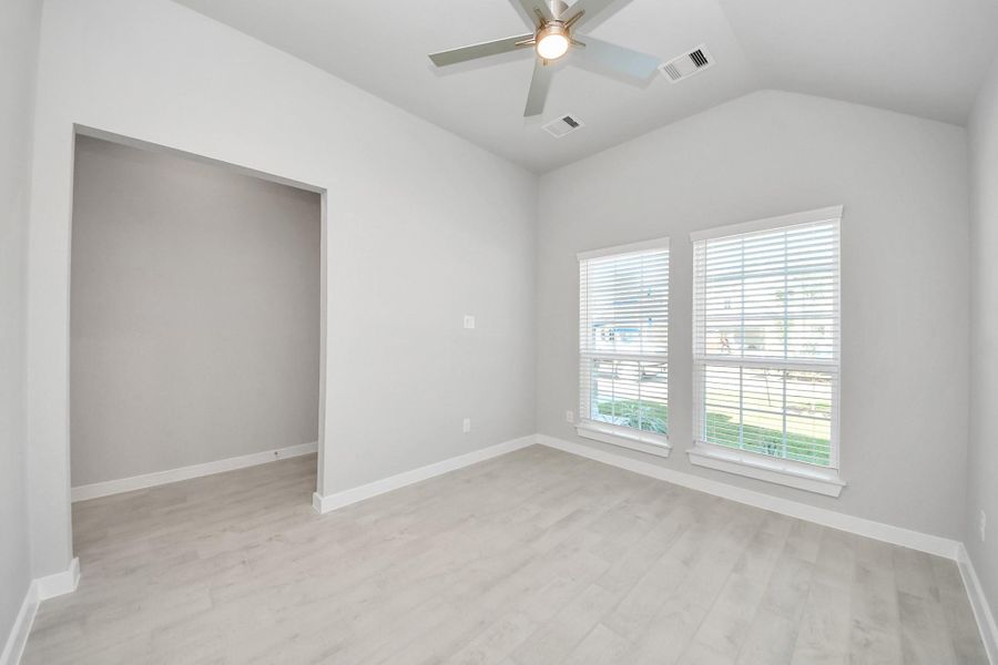 Experience the perfect blend of sophistication and warmth in this home office, boasting elegant wood-look tile flooring and flooded with natural light from expansive windows and French doors. Sample photo of completed home with similar floor plan. Actual colors and selections may vary. Experience the perfect blend of sophistication and warmth in this home office, boasting elegant wood-look tile flooring and flooded with natural light from expansive windows and French doors. Sample photo of completed home with similar floor plan. Actual colors and selections may vary.