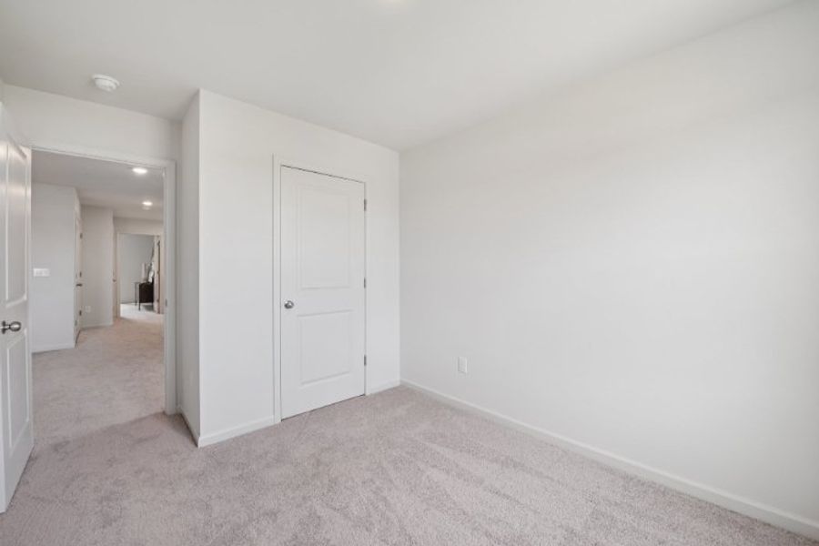 A hallway with white doors.