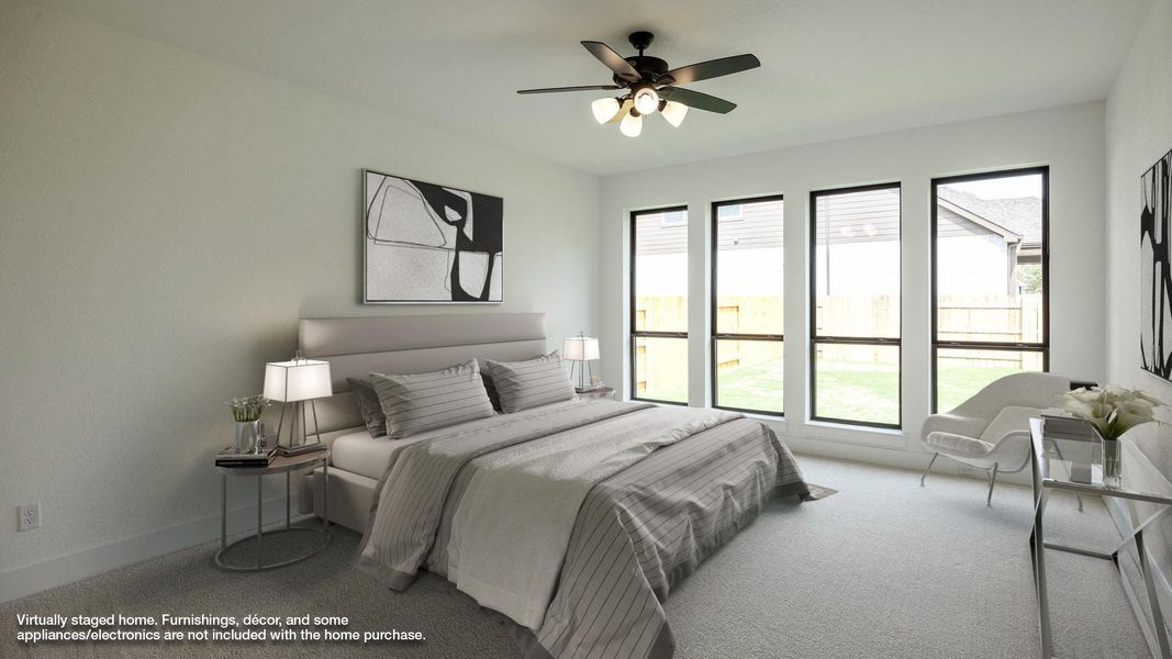 Carpeted bedroom featuring a ceiling fan and baseboards